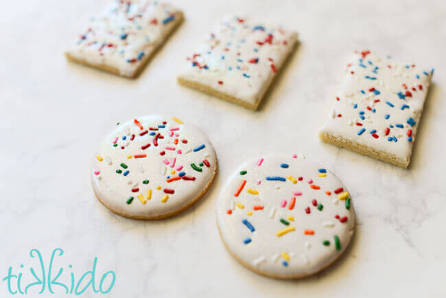 Sugar cookies dipped in royal icing and covered in sprinkles.