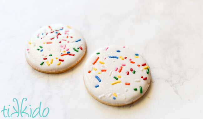 Sugar cookies dipped in royal icing and covered in sprinkles.