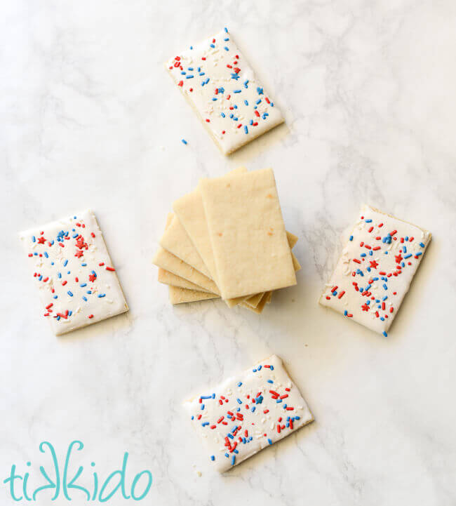 Sugar cookies coated in royal icing and covered in patriotic, red white and blue sprinkles.