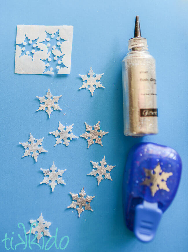 Soap coated wafer paper cut into snowflake shapes with a paper snowflake punch, and coated with body glitter.