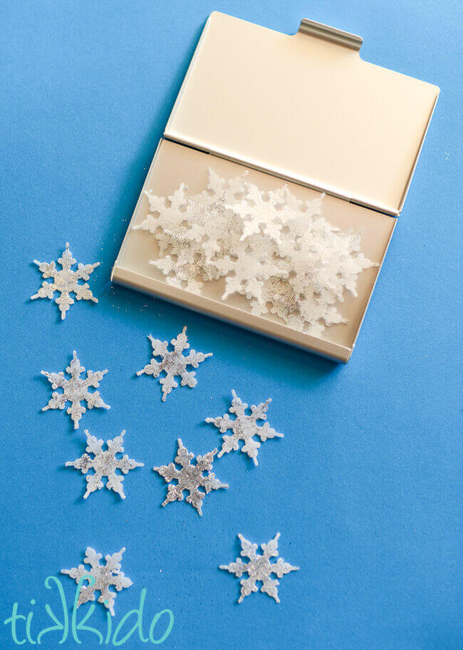 Business card holder tin full of single-use snowflake soaps.
