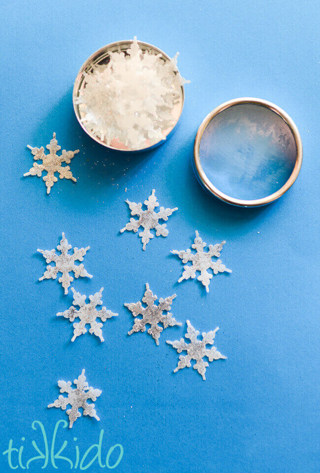 Small favor tin filled with paper-thin, single-use, miniature snowflake soaps.