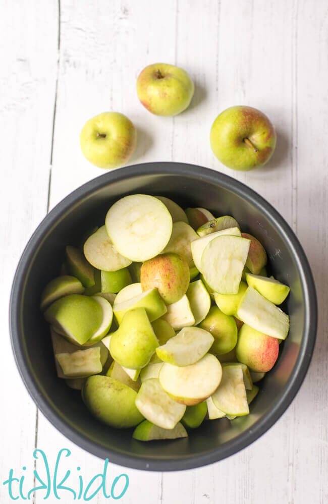 Chunks of apples in a pressure cooker inner pot ready to make instant pot applesauce.