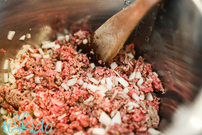 Onions and ground beef being browned in an Instant Pot to make Instant pot chili recipe