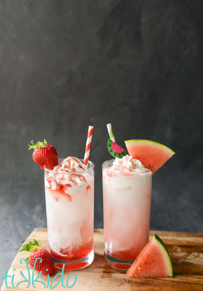 Strawberry and Watermelon homemade Italian cream sodas on a black background.