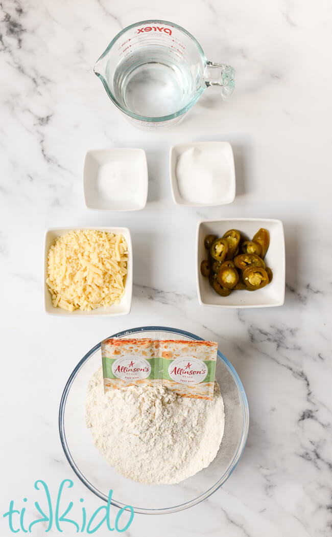 Ingredients for Jalapeño Cheddar Bagel recipe on a white marble surface.