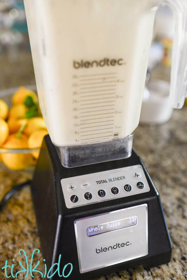 Fruit of lemons being blended in a blendtec blender for making lemon jam.