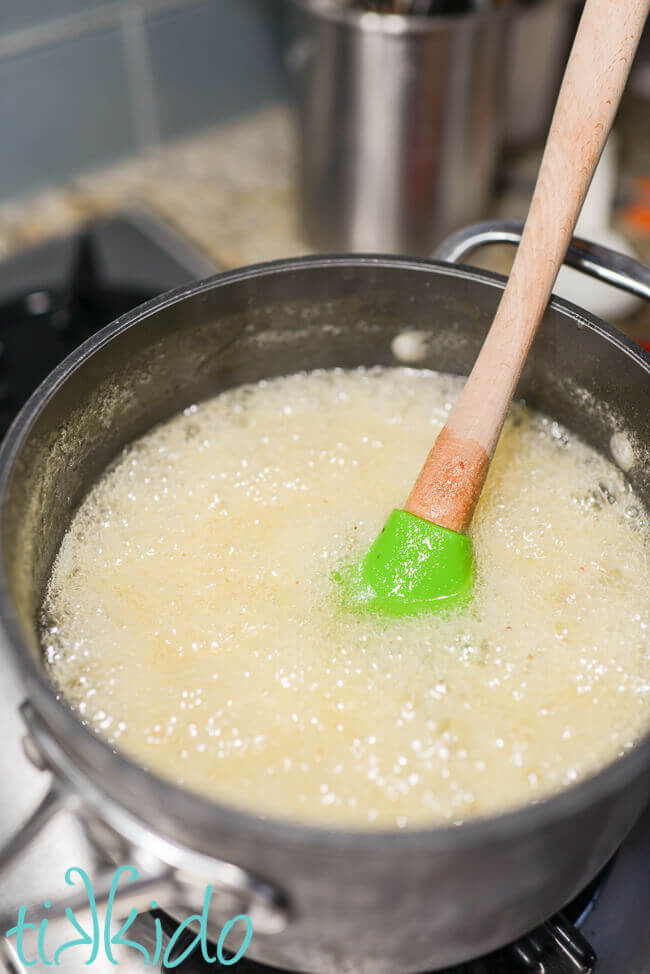 Homemade lemon jam being cooked in a pot on the stovetop.