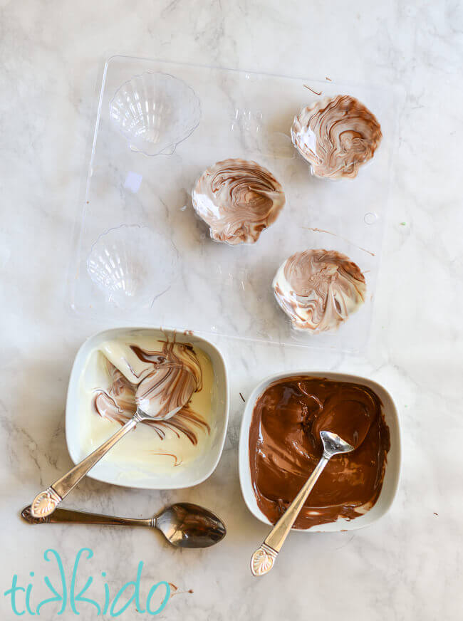 White chocolate and dark chocolate swirled together in a chocolate seashell mold.
