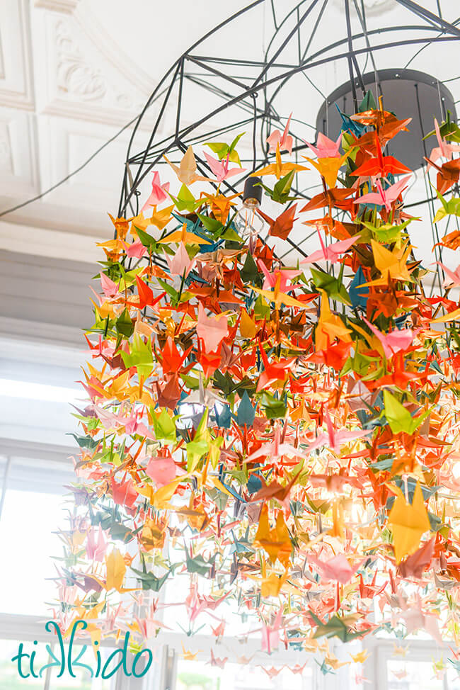Colorful modern origami crane chandelier at SORRY - PEČEME JINAK cafe in Brno, Czech Republic.