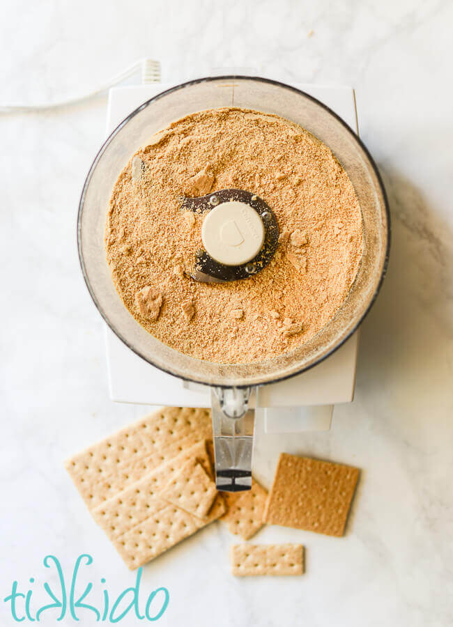 Graham crackers being turned into crumbs in a food processor.
