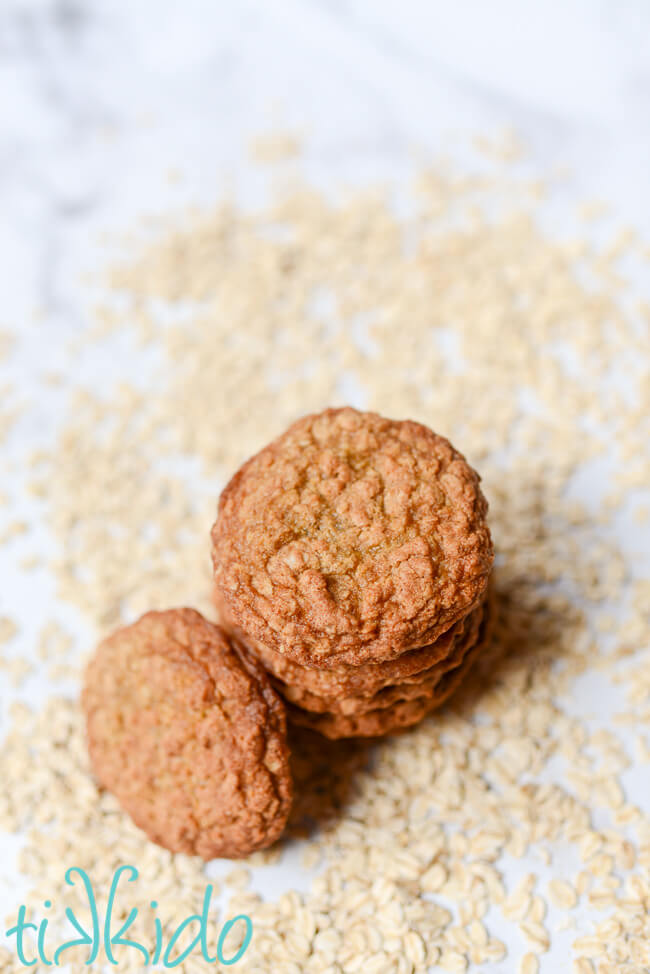 Stack of chewy oatmeal cookies surrounded by oats.