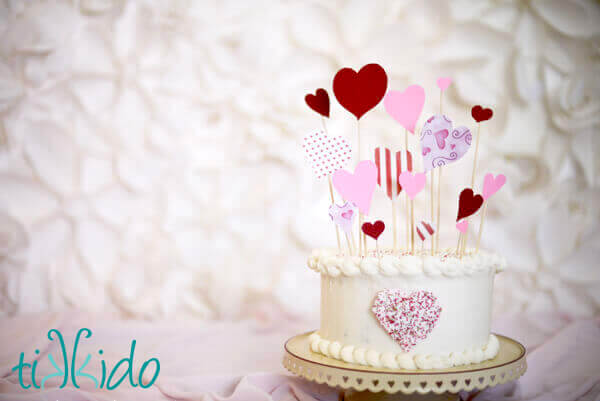 Cake decorated with an easy Valentine's Day Cake Topper made from paper hearts and bamboo skewers.