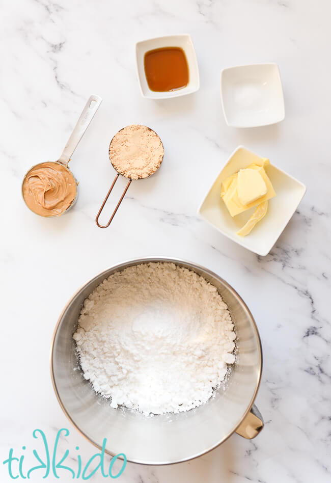 Peanut Butter Frosting Recipe ingredients on a marble surface.