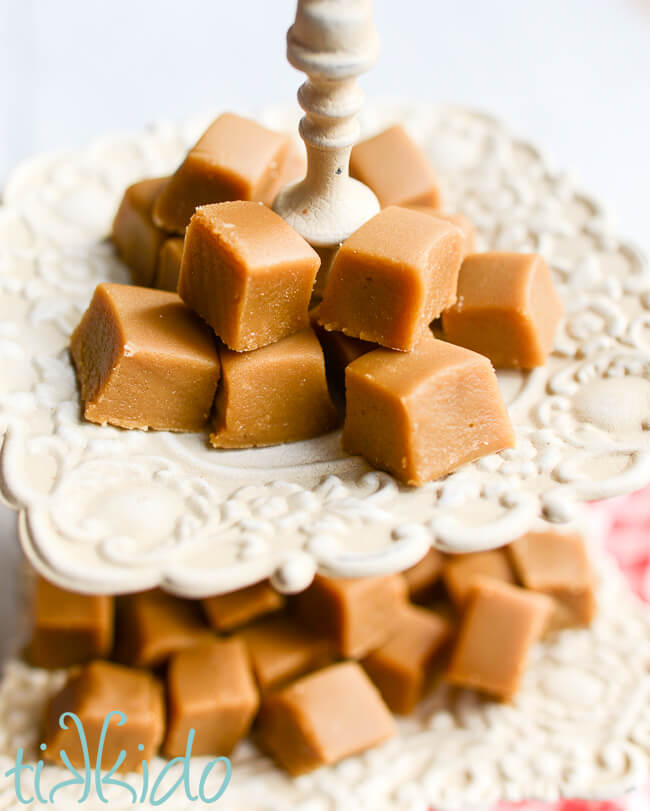 Two tiered white serving tray piled high with pieces of old fashioned penuche fudge.