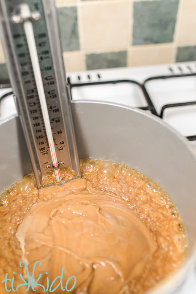 Penuche fudge mixture cooking in a saucepan, the mixture just beginning to bubble at the edges of the pan.