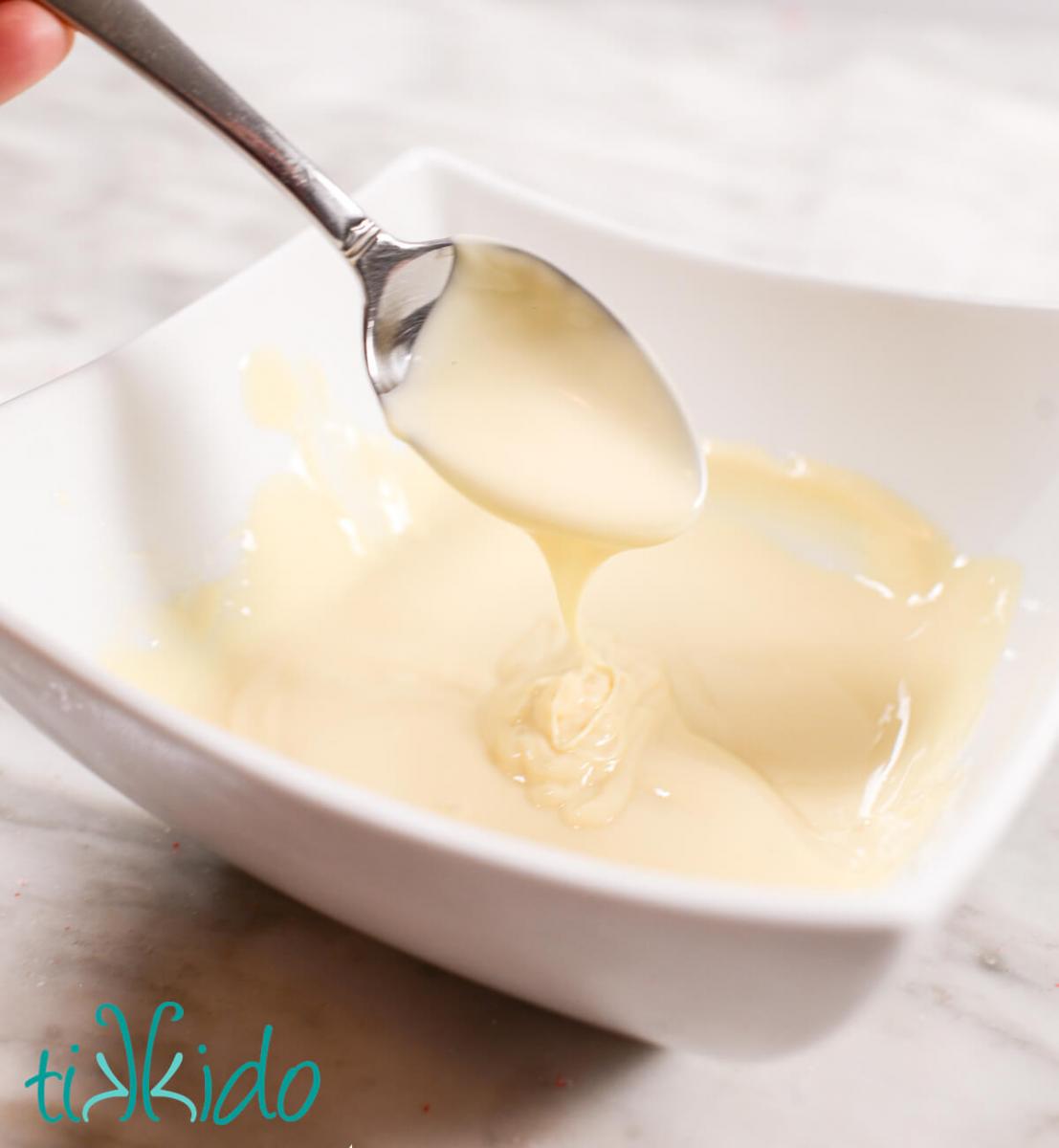 White chocolate completely melted to make peppermint white chocolate covered pretzels.