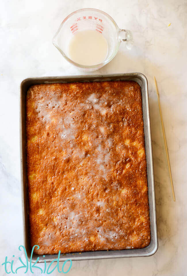 Pina Colada poke cake with coconut milk and pineapple juice soaking in the cake.