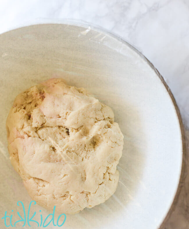 Kolache dough rising in a greased, covered bowl.