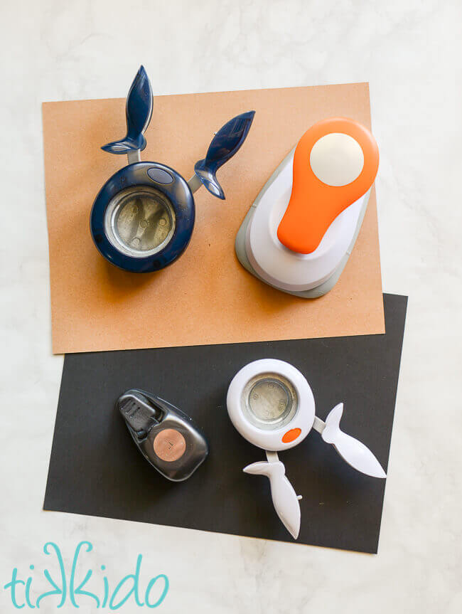 Various sizes of round paper punches on top of brown and black cardstock.