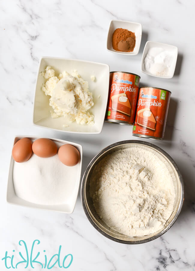 Ingredients for Pumpkin Cookies Recipe on a white marble surface.