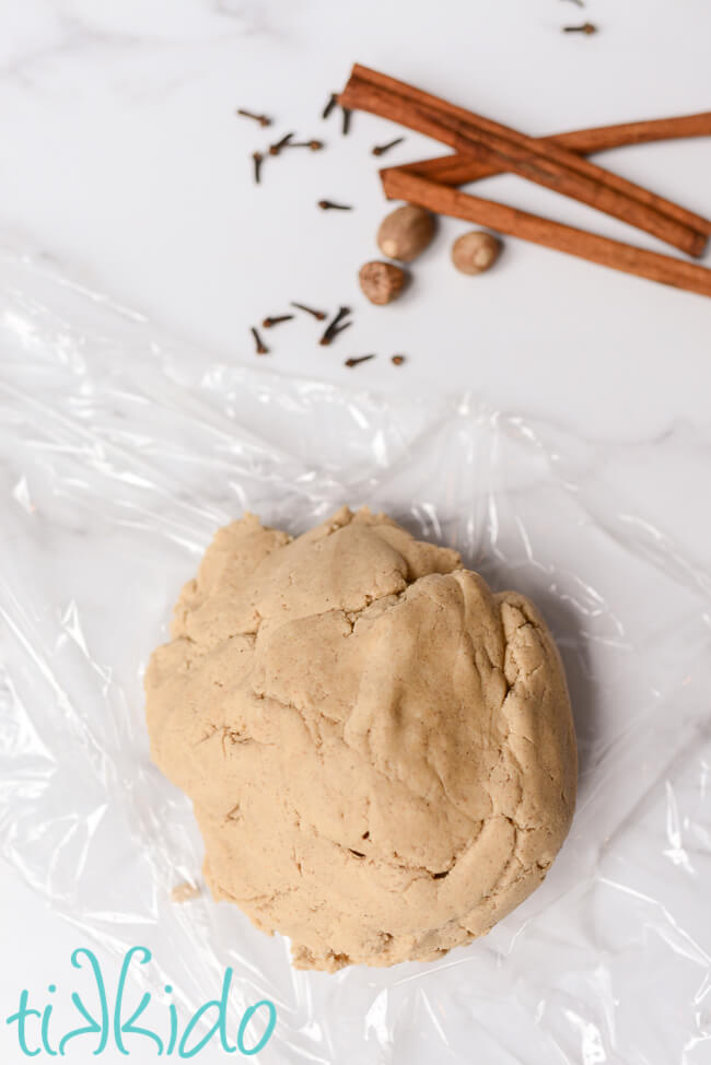 Pumpkin Spice Sugar Cookie dough and pumpkin pie spices on a white marble surface.