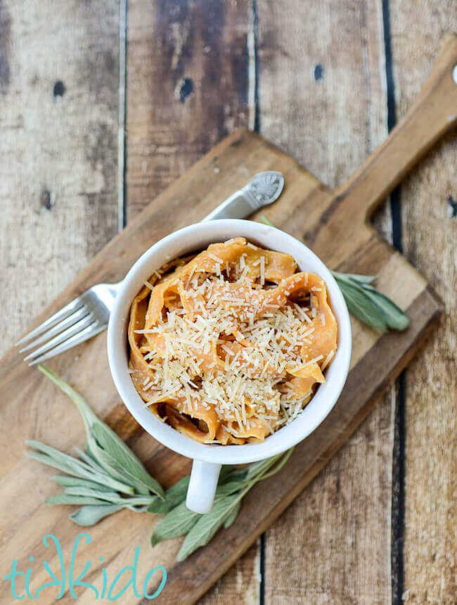 Bowl of pumpkin pasta with sage brown butter and parmesan cheese.
