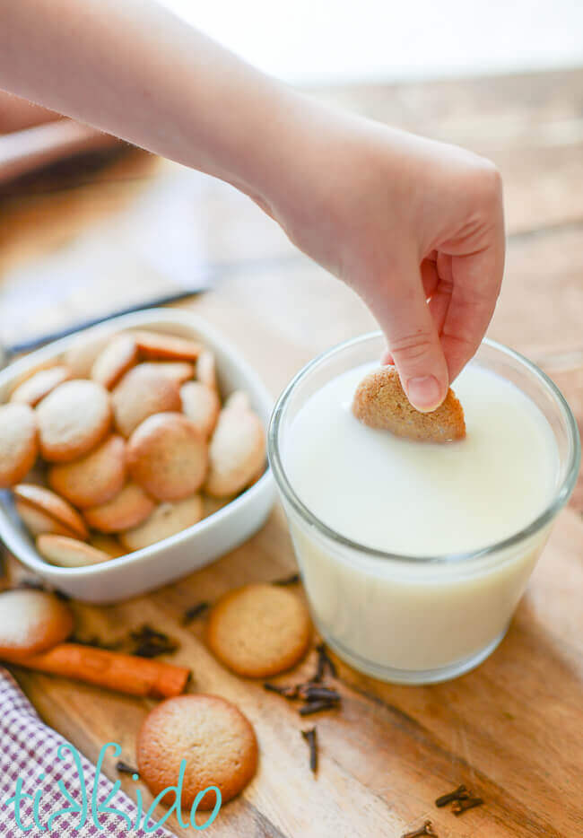 Pumpkin Spice Vanilla Wafer Cookies being dunked into a glass of milk.