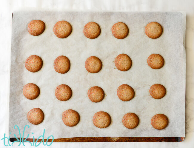 Pumpkin Spice Vanilla Wafer Cookies baked on a parchment lined cookie sheet.