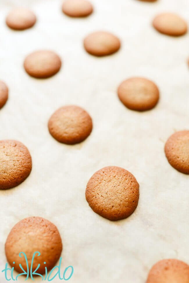Pumpkin Spice Vanilla Wafer Cookies baked on parchment paper lined cookie sheet.