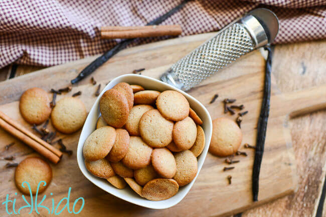 Pumpkin Spice Vanilla Wafer Cookies in a white bowl on a wooden cutting board.
