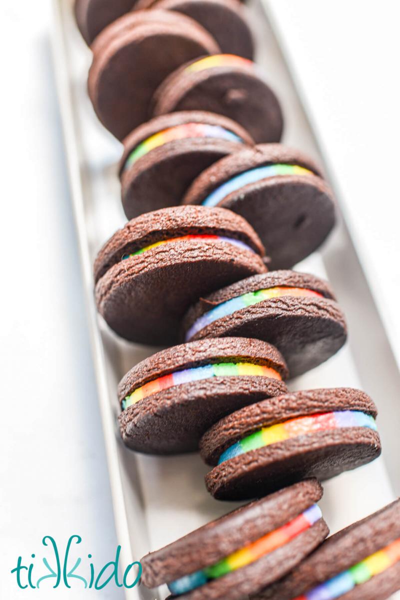 Side view of homemade rainbow oreos so that you can see the perfect full rainbow of colors filling each sandwich cookie.  