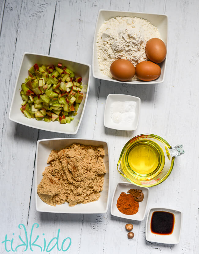 Ingredients for Rhubarb Bread Recipe measured out on a white wooden surface.