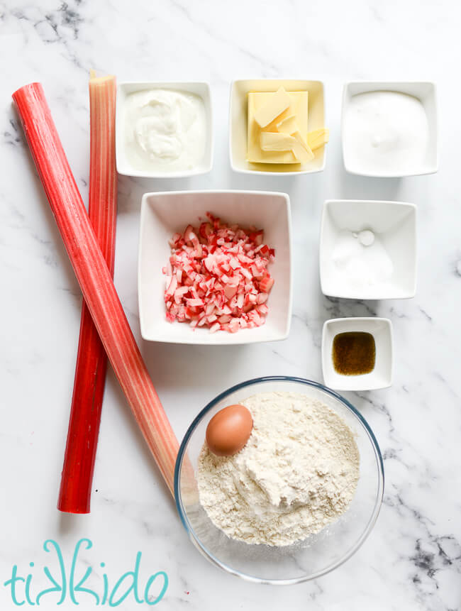 Ingredients for rhubarb scones recipe on a white marble surface.