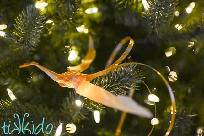 Golden Woven Ribbon Bird perched in a Christmas tree.