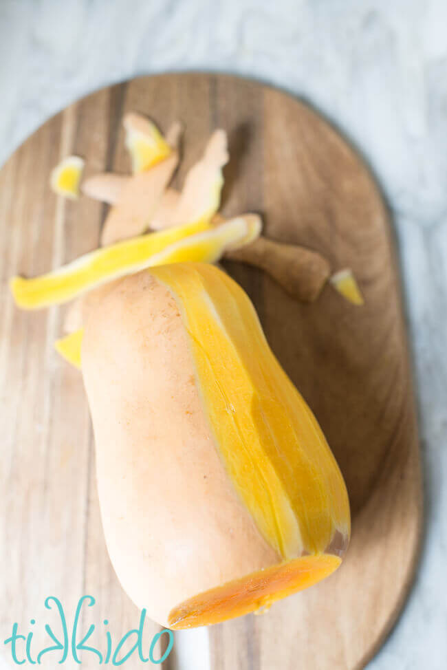 Butternut squash being peeled before roasting.