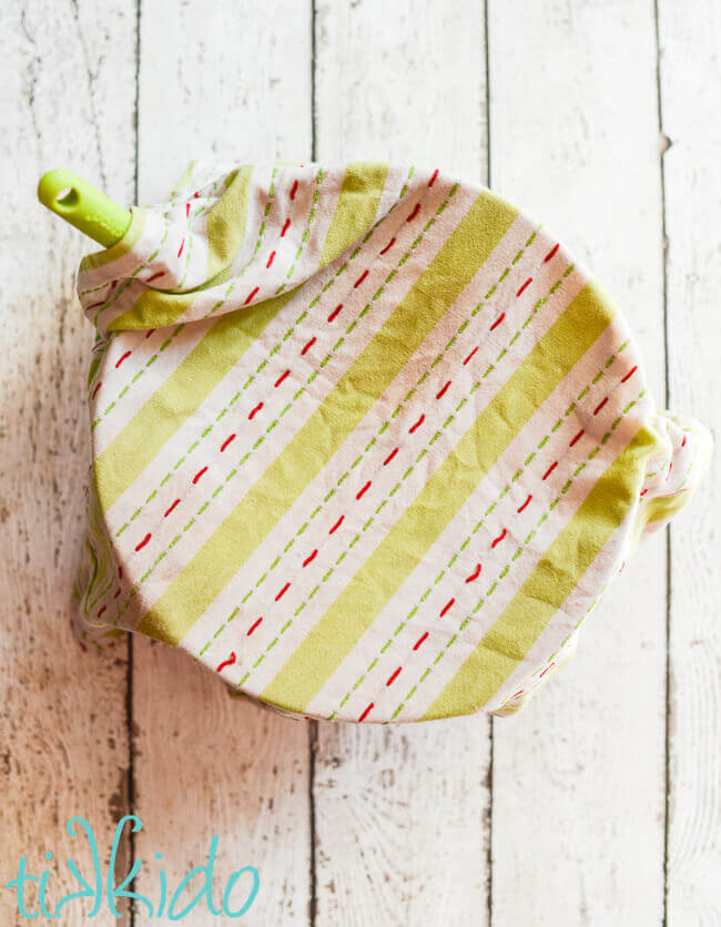 Bowl of royal icing covered with a damp kitchen towel.