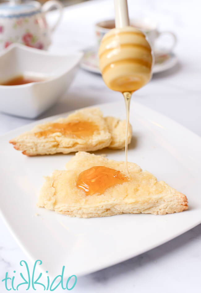 honey being drizzled on scones made with an easy scones recipe.