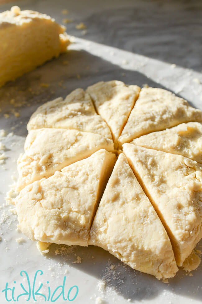 Circle of scones dough shaped in a circle and cut into eight wedges.