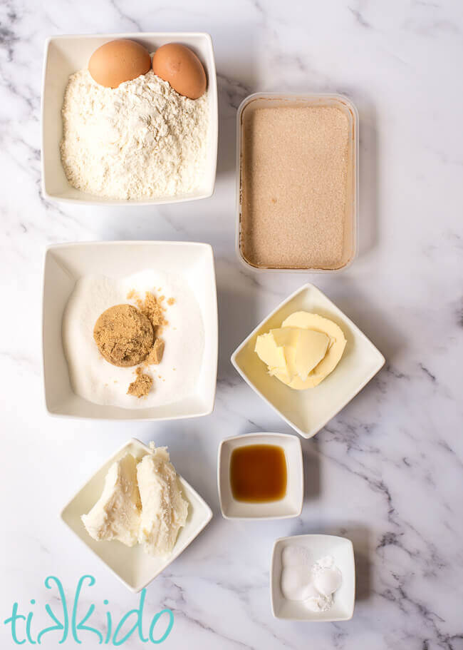 Ingredients for snickerdoodle cookie recipe on white marble table.