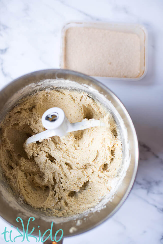 Batter for snickerdoodle cookie recipe in a silver mixing bowl.