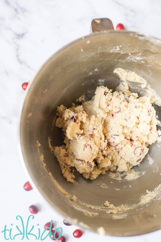 Cranberry cookie dough in a silver mixing bowl.