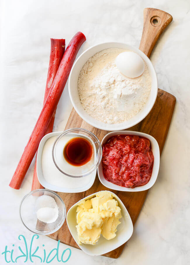 Ingredients for recipe for rhubarb cookies on a wooden cutting board.
