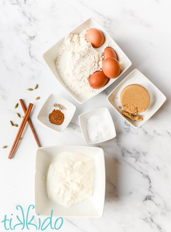 Ingredients for sour cream coffee cake on a white marble surface.