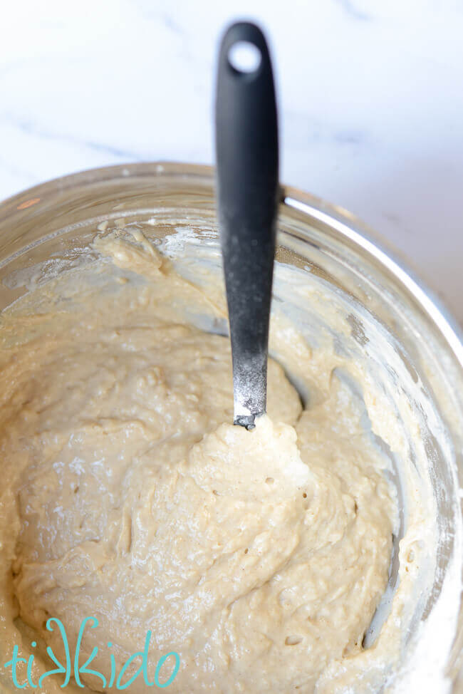 Sour cream coffee cake batter in a silver bowl.