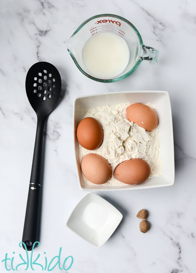 Ingredients for spaetzle recipe on a marble surface.