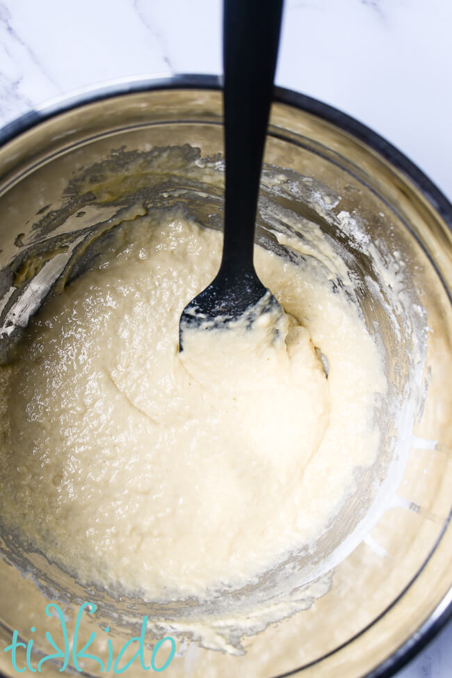 Batter for spaetzle recipe in a silver mixing bowl.