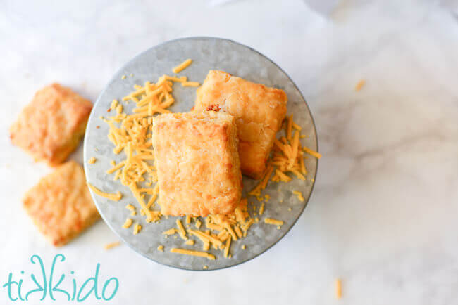 Sriracha Cheddar Biscuits  stacked on a galvanized metal cake stand.