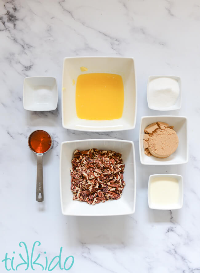 Ingredients for sticky buns caramel pecan sauce on a white marble surface.