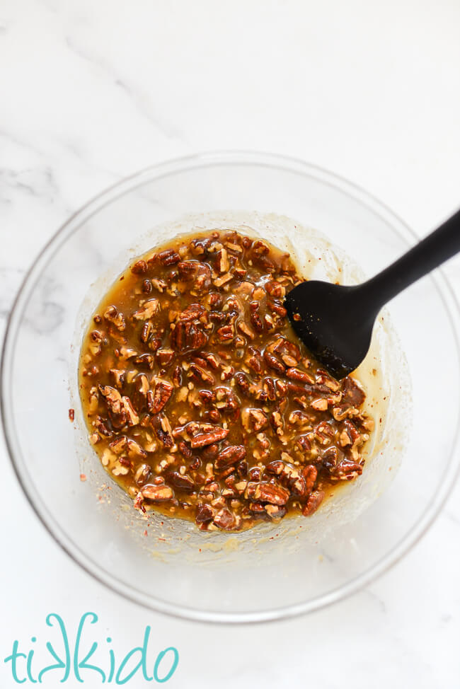 Caramel pecan sauce for sticky buns in a clear mixing bowl.
